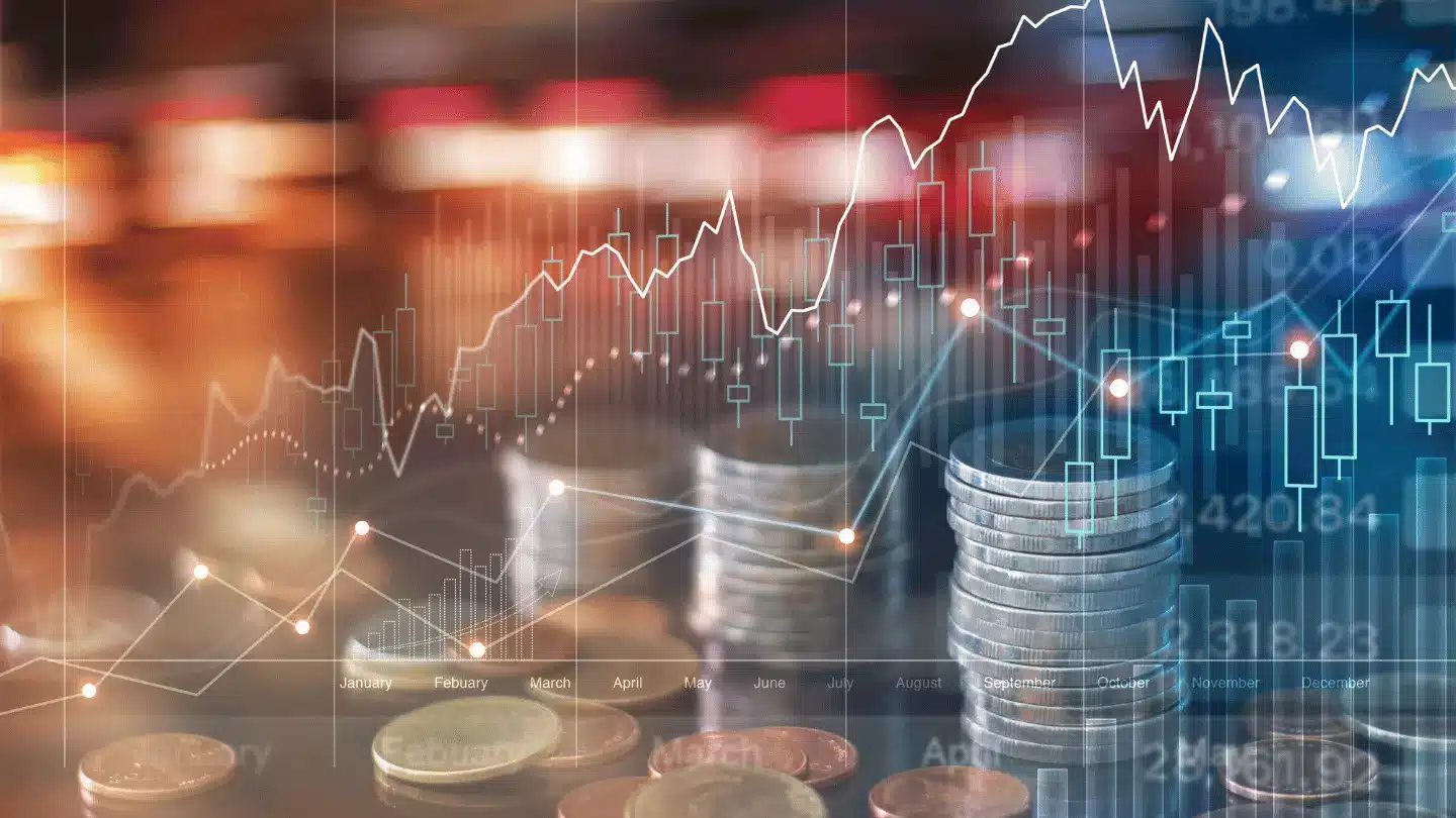 Financial market charts and stacked coins representing investment growth